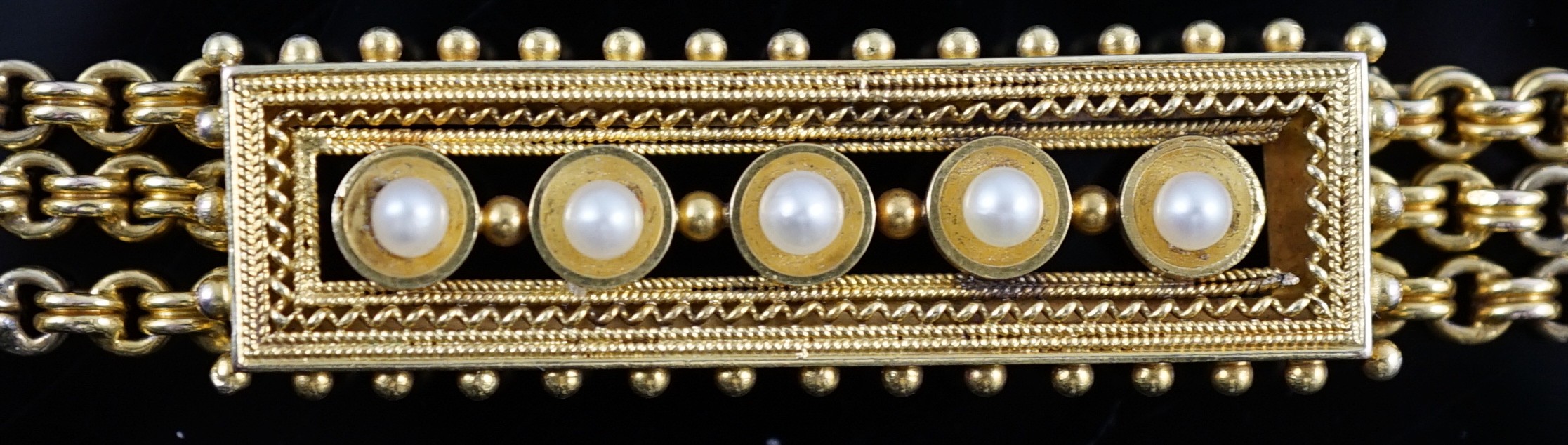 An early 20th century triple strand gold bracelet with central rectangular motif set with five cultured pearls